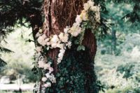 25 a tree fully covered with neutral florals and lush greenery can be used as a ceremony backdrop