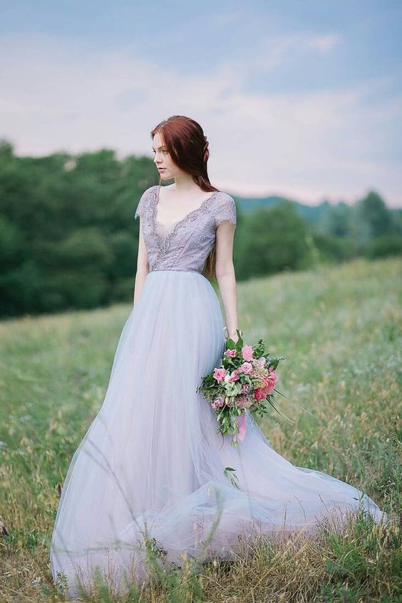 a lavender wedding gown with an embellished V neckline, short sleeves and a light layered skirt