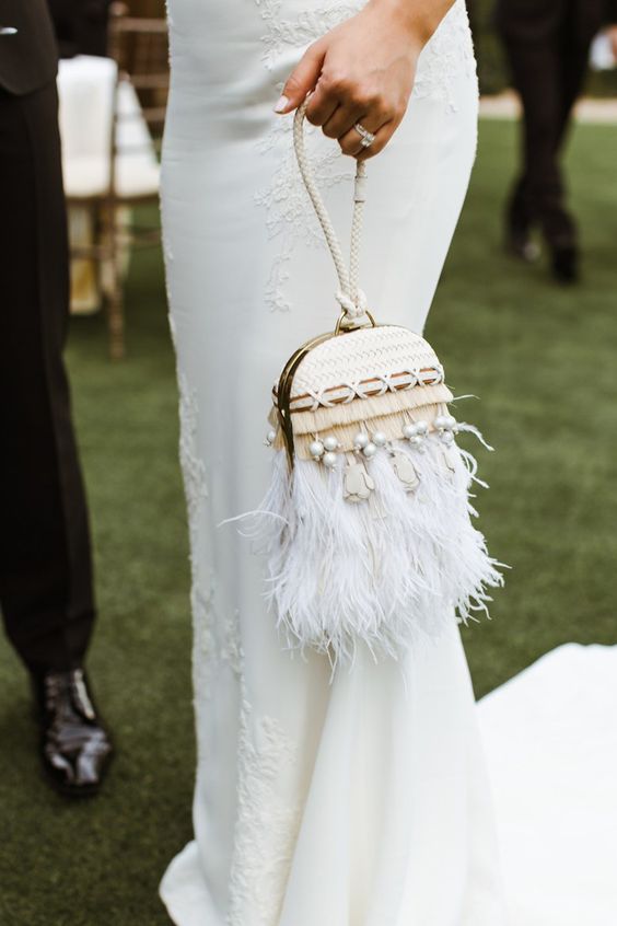 a super whimsy woven bridal clutch on a long loop, with fringe, pearls and leather cord detailing