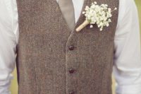 26 tan pants, a white shirt, a grey tie, a brown tweed vest and a baby’s breath boutonniere