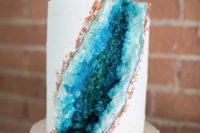 28 a wedding cake with copper leaf and blue geodes for a trendy wedding