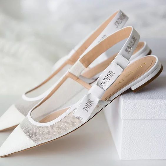 classy and trendy white slingbacks with semi-sheer parts and pointed toers plus logo straps are a cool solution not only for a wedding