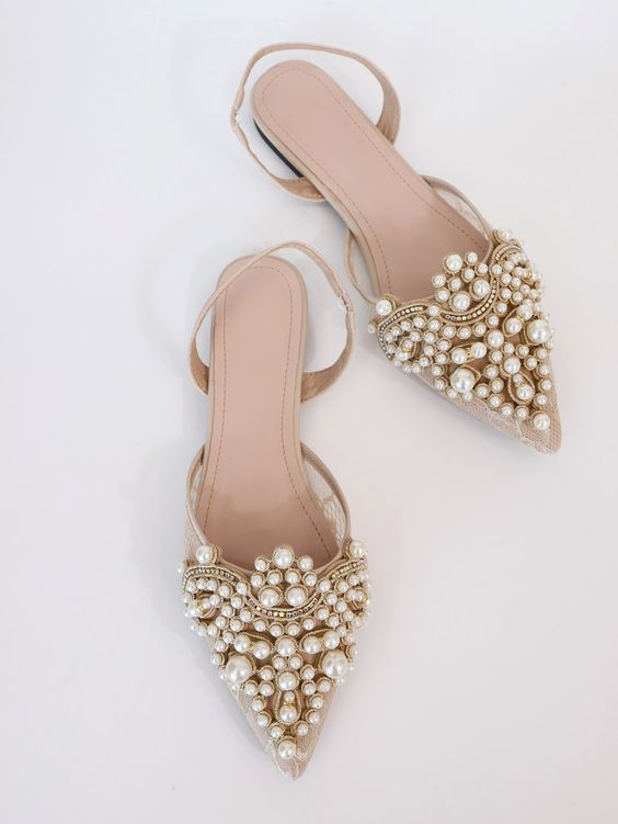 nude pointed toe wedding shoes with pearls all over the tops are a super glam, chic and catchy solution for a bridal look