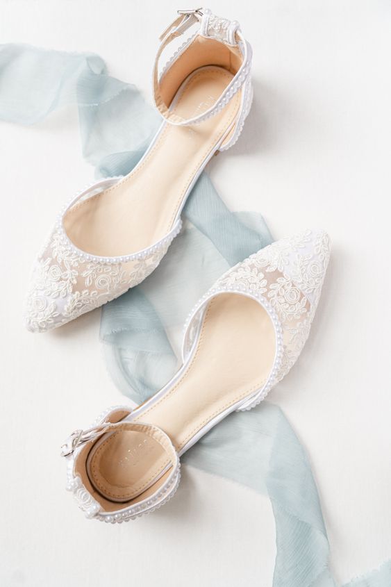white lace wedding flats with ankle straps and little pearls are a very chic and catchy solution for a wedding