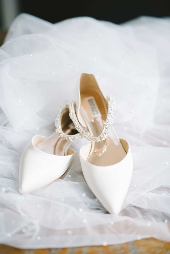 white pointed toe wedding shoes with embellished ankle straps are amazing for a modern and glam bridal look