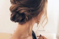 02 a chic twisted low bun with a small bump and some locks down for a timelessly romantic look