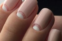 02 a fresh take on French manicure with half moon whites and light pink base is an edgy idea