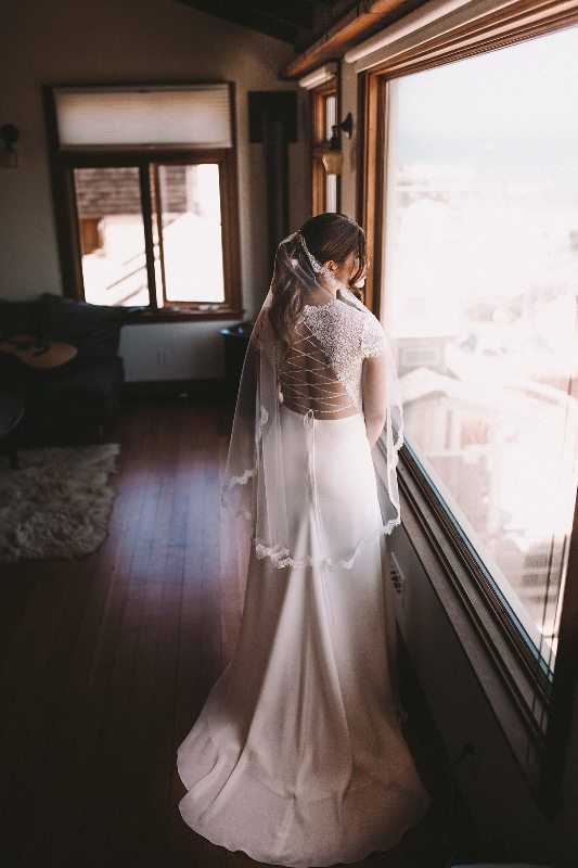 She was rocking a fitting wedding dress with a sheer lace illusion bodice and a lace up back plus a small train