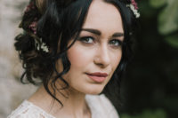 03 She was rocking a loose halo braid with flowers and leaves scattered between for a rustic chic and boho feel