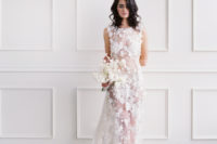 03 The bride was wearing a stunning sheer wedding dress with no sleeves, fully covered with white floral appliques