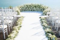 03 a luxurious white bloom and greenery semi circle wedding altar, the same lining for the aisle and a gorgeous seascape