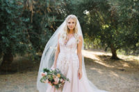 Her gorgeous wedding dress was a lush one with white lace floral appliques and a deep V-neckline