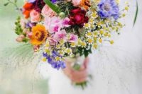 04 a colorful wildflower wedding bouquet in purple, yellow, pink, fuchsia and with greenery and herbs