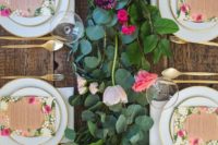 04 a fresh floral and greenery garland, floral menus and gold flatware for a cute garden-inspired tablescape