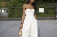 04 a white strapless jumpsuit with culottes, black lace up heels and a metallic small bag