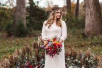 05 a gorgeous boho fall wedding altar with dried grasses and leaves, greenery and plum-colored blooms