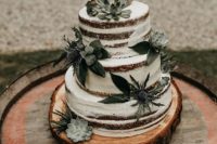 05 a naked buttercream sponge wedding cake with thistles and succulents plus a calligraphy topper