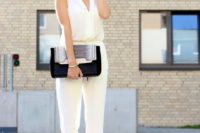 05 a white sleeveless fitting jumpsuit with a V-neckline, black ankle strap shoes and a matching clutch for a modern bride
