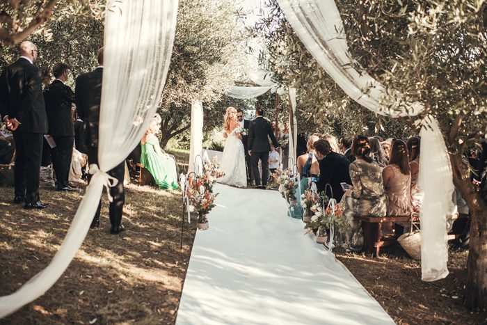 The wedding ceremony space was placed in an olive grove and with airy fabric
