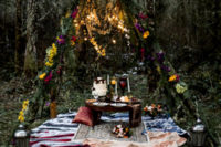 06 There was a teepee in the woods covered with ferns and colorful blooms and lights plus a picnic setting