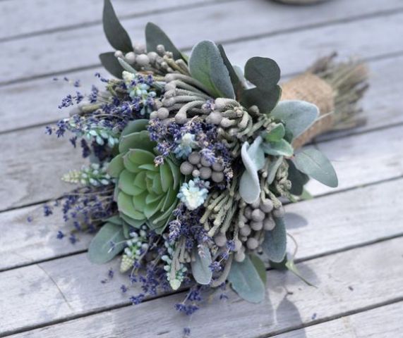 a chic pale wedding bouquet with lavender, berries and a succulent in the middle