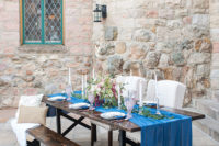 07 The table was laid in the yard of the castle, it was an uncovered wooden table and benches with fur and a blue velvet runner