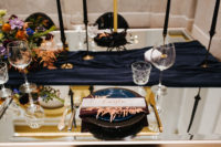 07 The wedding table setting was done with a mirror table, chic plates, black candles, a velvet table runner and a refined feel