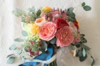 07 a bright bouquet in pink, yellow, red with eucalyptus and navy ribbons for a colorful summer wedding
