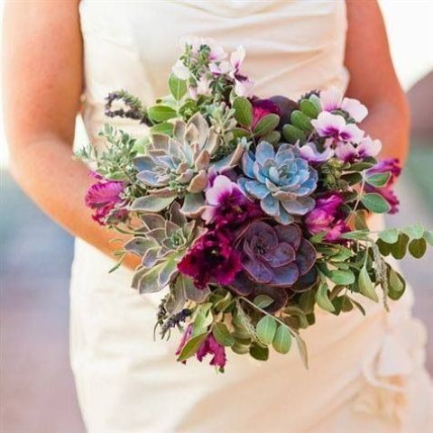 a chic wedding bouquet with pale green and purple succulents, fuchsia blooms and greenery