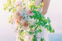 07 a creative textural wedding bouquet with bold greenery and some blush peonies