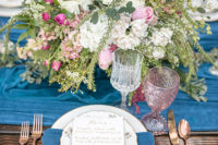 08 Colored glasses, blue napkins, calligraphy and rose gold flatware added a romantic feel to the table setting