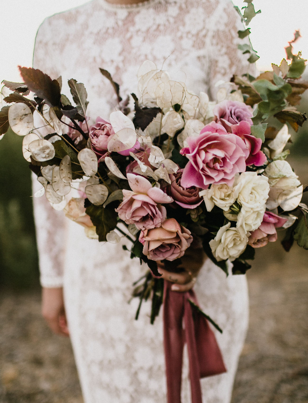 Look at the gorgeous bridal bouquet with pink roses and dusty pink ribbons