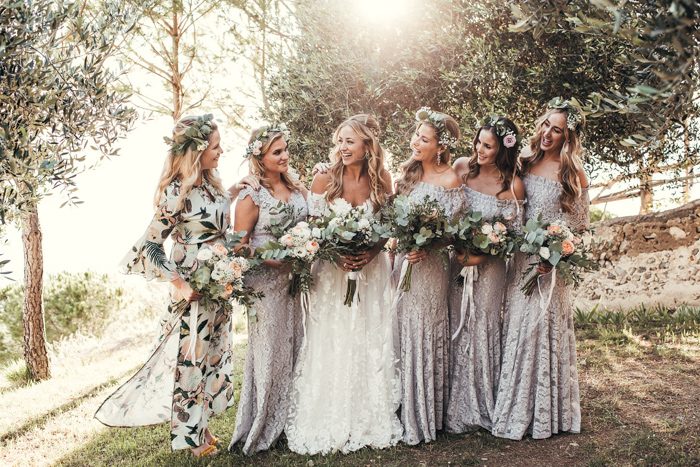 The bridesmaids were wearing lilac lace dresses by the bride's fashion brand