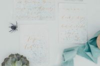 08 The wedding stationery was done with a seaside feel, it was splattered with blue dots and with copper calligraphy