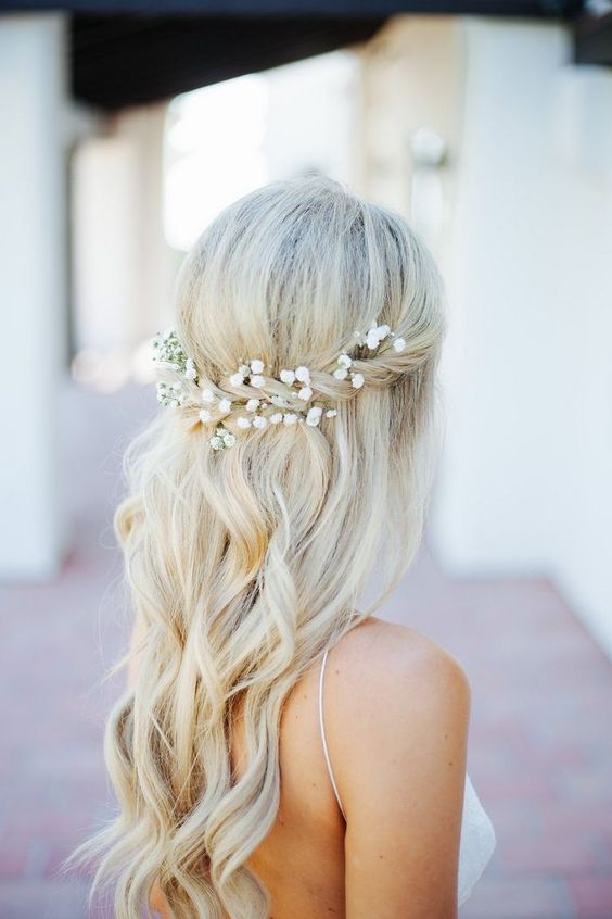 a half updo with a halo with baby's breath and waves down for a romantic look