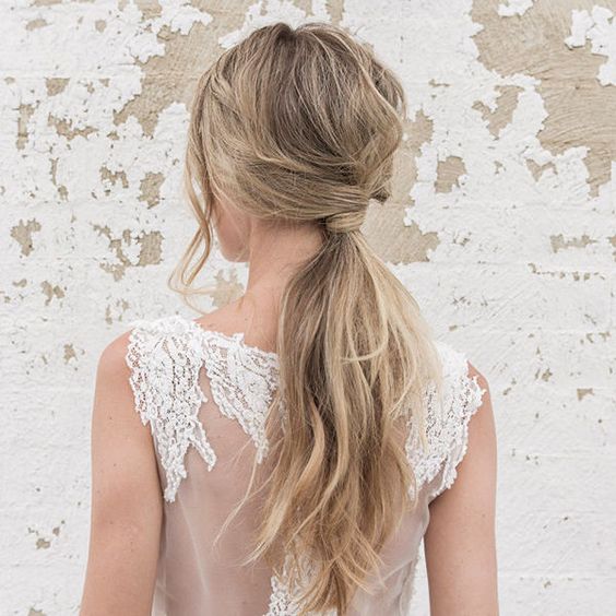 a messy textured and wavy ponytail with some locks down and a twist is a cool idea to rock