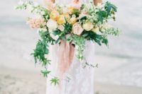 08 a soft-colored wedding bouquet with cascading greenery, peachy and blush blooms for a pastel touch