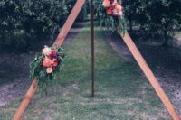 08 a triangle wedding arch with lush bright flowers and foliage for a garden boho wedding
