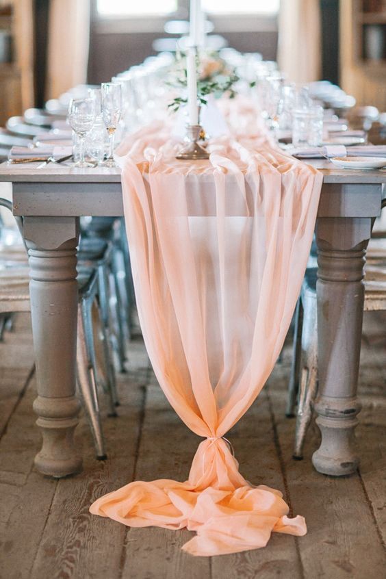 an airy and semi sheer peachy pink table runner for an elegant and luxurious touch