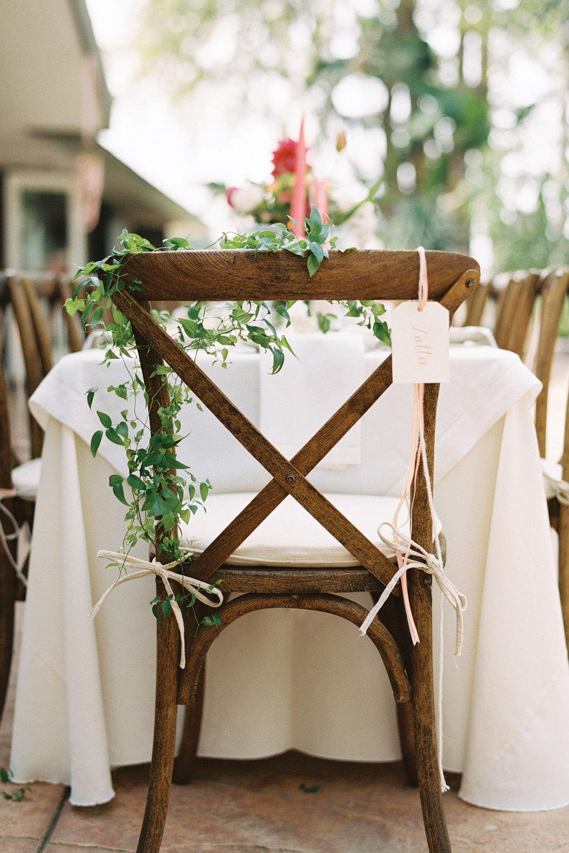 Decorate the chairs with delicate greenery garlands, ribbons and tags, so you won't need any place cards