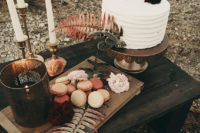 09 A small picnic table included a wooden tray with macarons, candles and a buttercream cake decorated with cacti