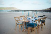09 The wedding tablescape was right on the beach, with bold and catchy shades of blue and cool prints
