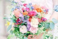 09 a cute wedding bouquet in fuchsia, blush, orange and purple shades and textural greenery shows off a mix of muted and bold tones