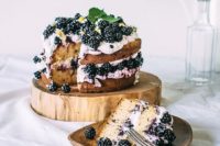 09 a naked wedding cake with blackberries and fresh mint on top for a mouth-watering look and taste