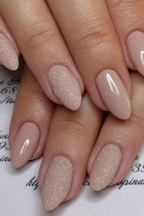 nude manicure with touches of glitter on some nails will add a glam feel to your look