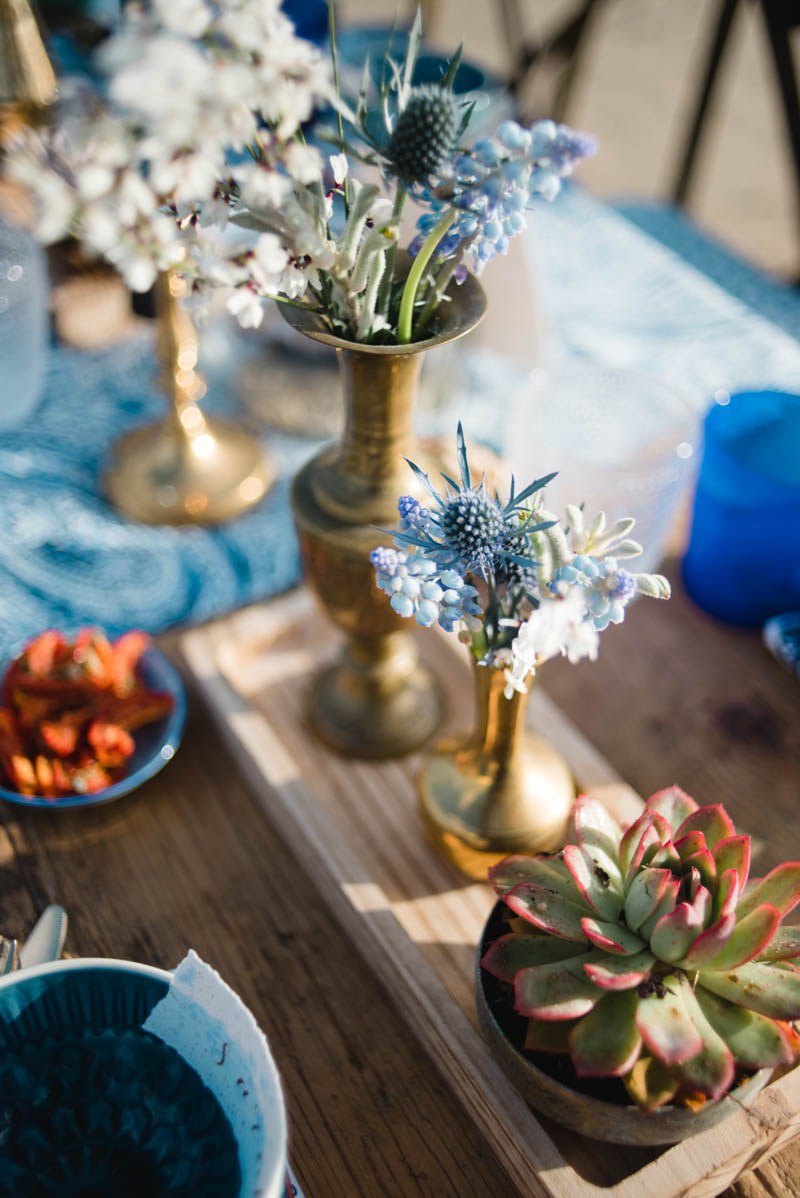 Beautiful blue and white blooms and succulents were used for table decor to give it a coastal feel