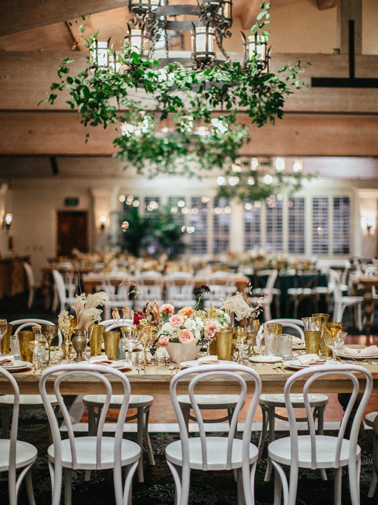 The wedding venue was decorated with greens, delicate florals and gilded touches