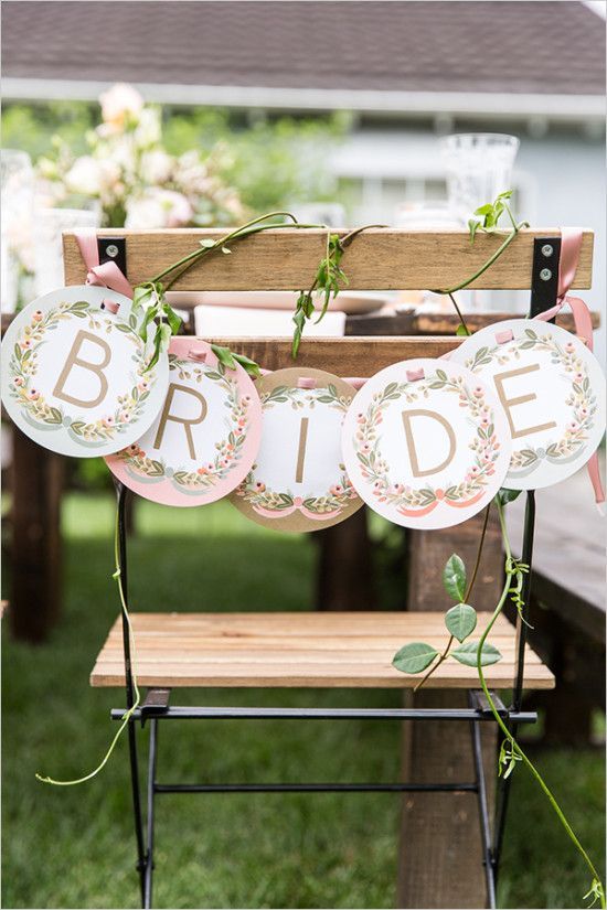 a letter banner with fresh greenery to decorate the bride's chair is a cute and easy to make idea