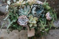 10 a wedding bouquet with pale grey, green and purple succulents and berries and a lace wrap