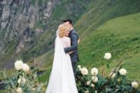 11 an organic greenery and white blooms outdoor wedding altar helps to enjoy the highlands around